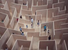Groups of people trying to navigate a difficult maze